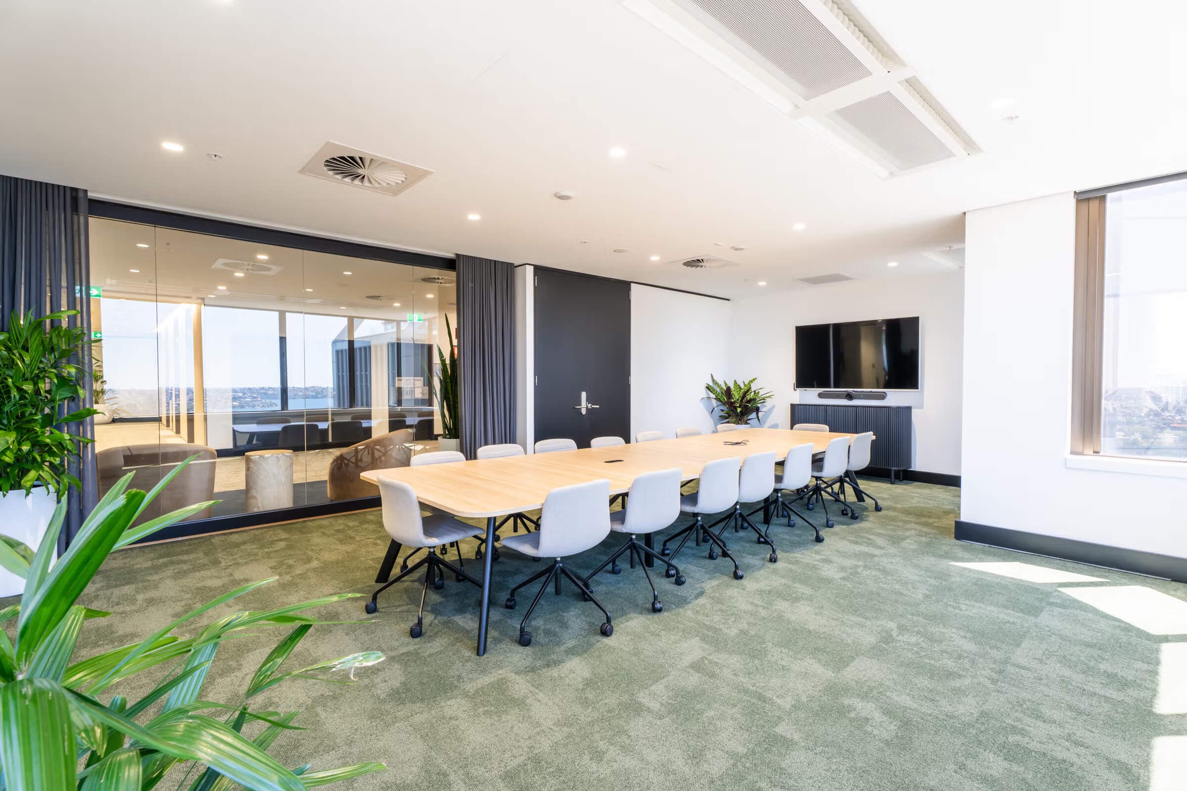 Bright private office suite with modern desks, glass partitioning, and natural light. Bright private office suite with modern desks, glass partitioning, and natural light.