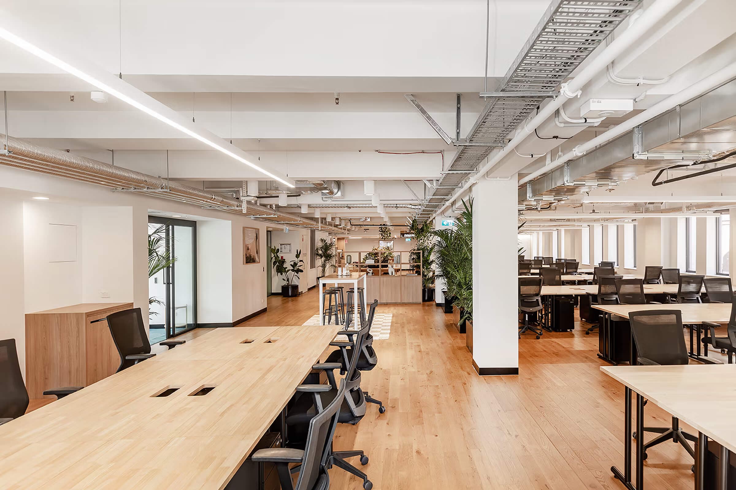 Spacious open-plan workspace with modern layout and ergonomic furniture. Spacious open-plan workspace with modern layout and ergonomic furniture.