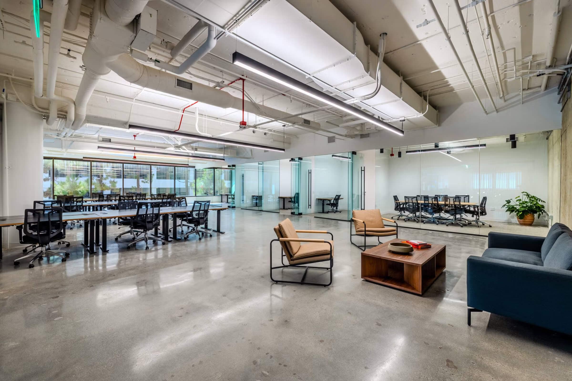 Open-plan flexible coworking space with modern interior and lounge seating. Open-plan flexible coworking space with modern interior and lounge seating.