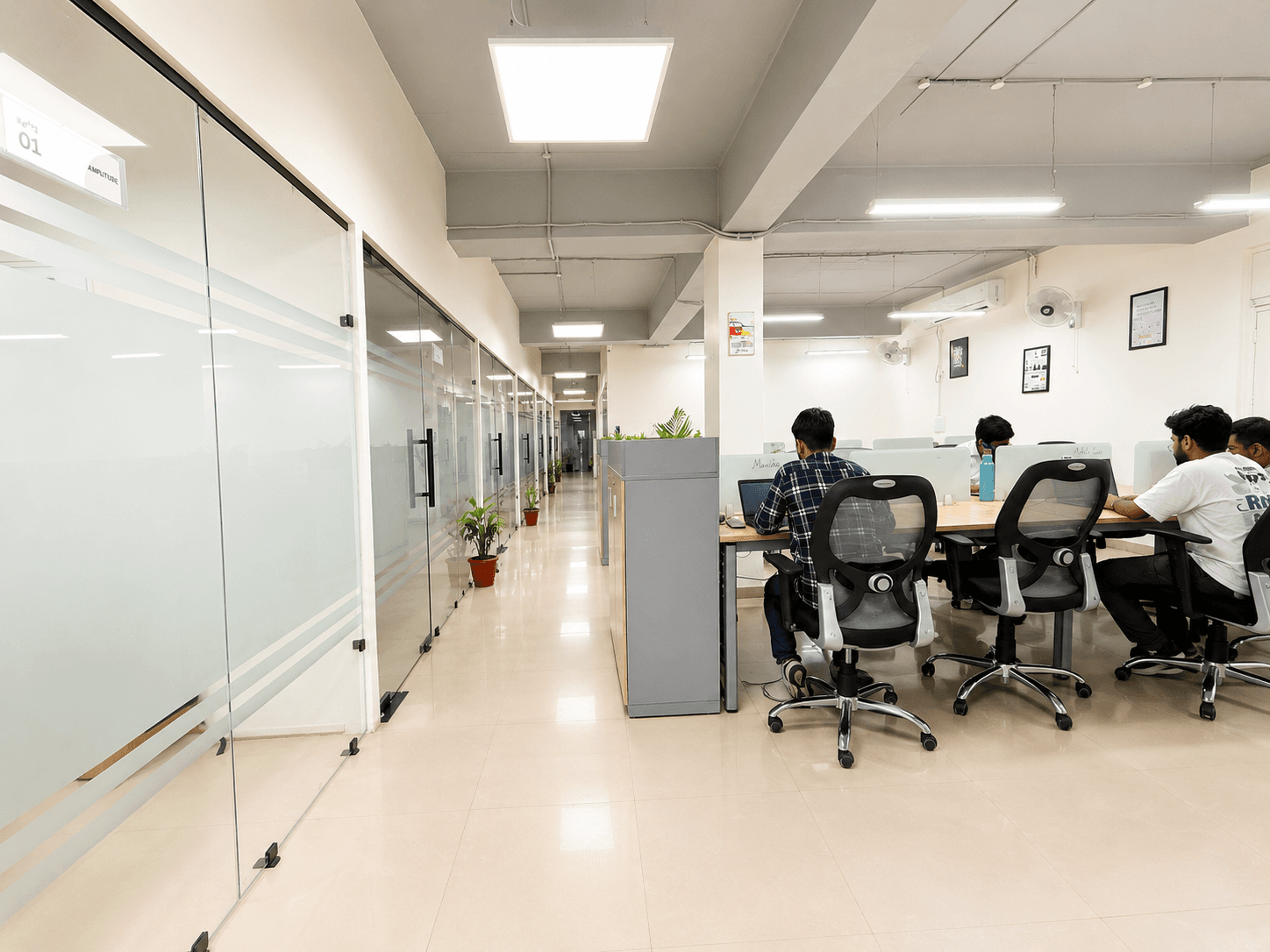 Wide, well-lit walkway linking workstations and cabins with a clean, professional layout. Wide, well-lit walkway linking workstations and cabins with a clean, professional layout.