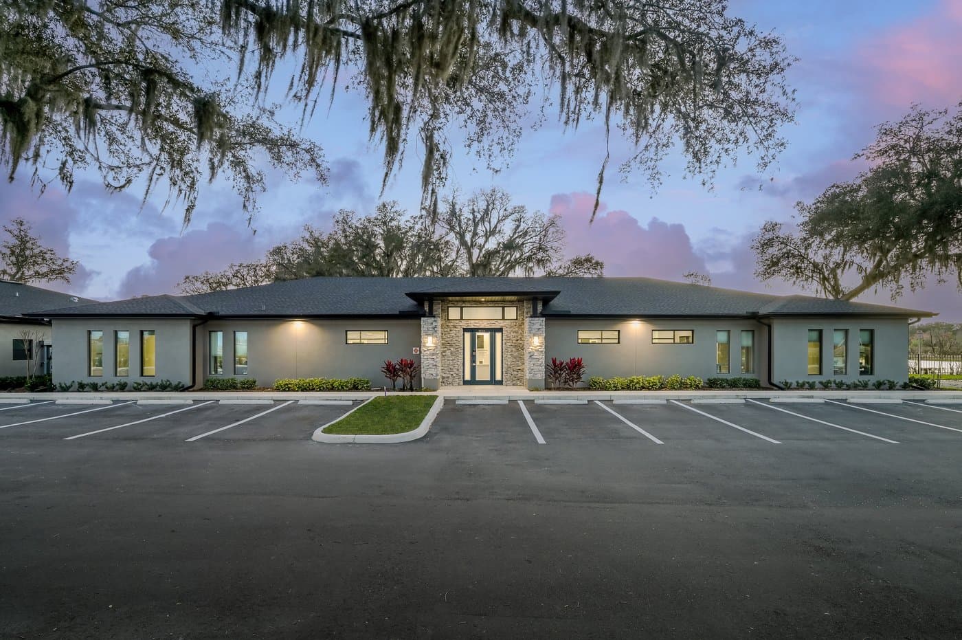 Front of the single-story Mango Space Wesley Chapel building at dusk, with free parking right outside. Front of the single-story Mango Space Wesley Chapel building at dusk, with free parking right outside.