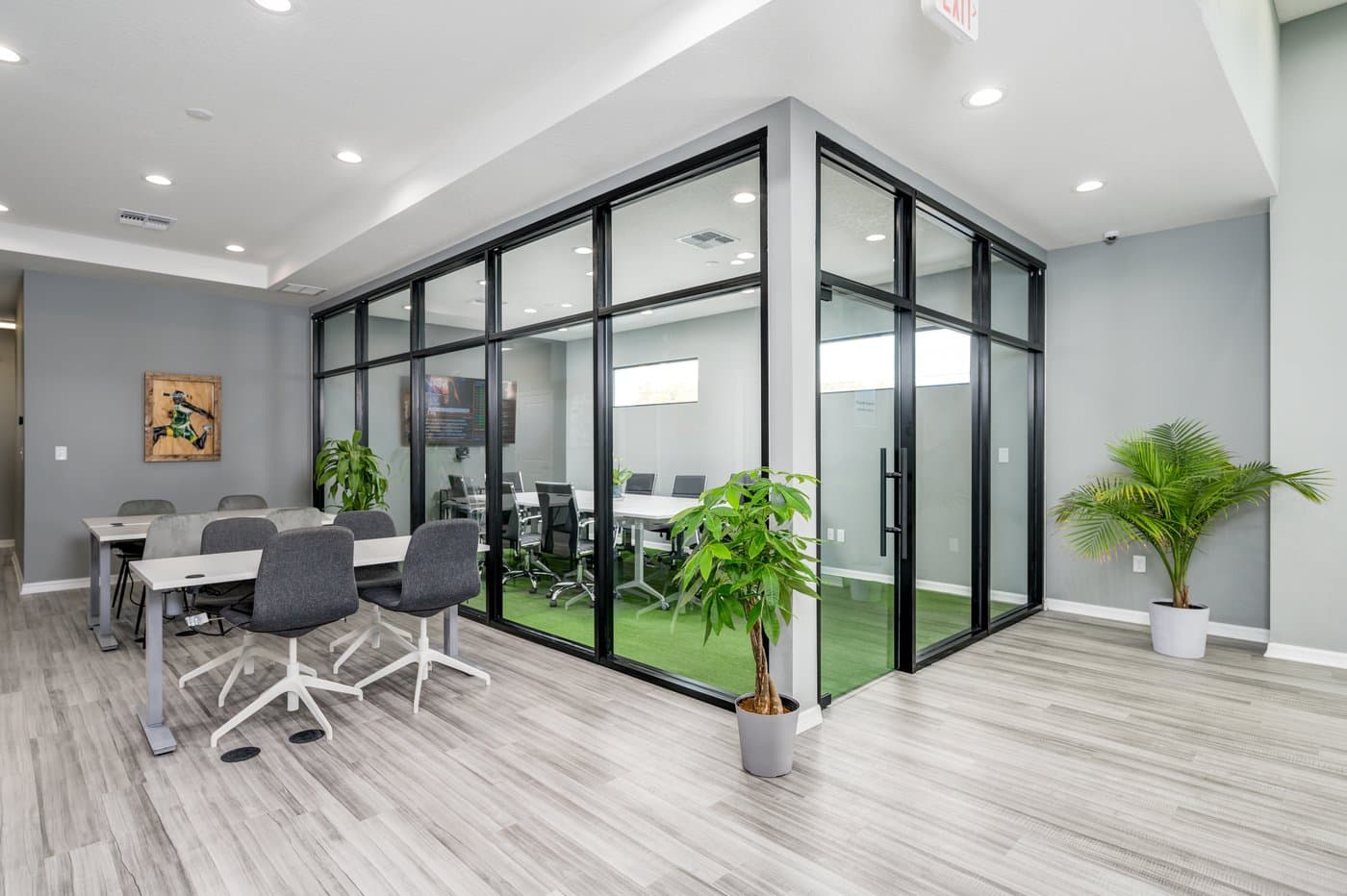 Open common area with wood-look floors, local art and glass-walled meeting rooms. Open common area with wood-look floors, local art and glass-walled meeting rooms.