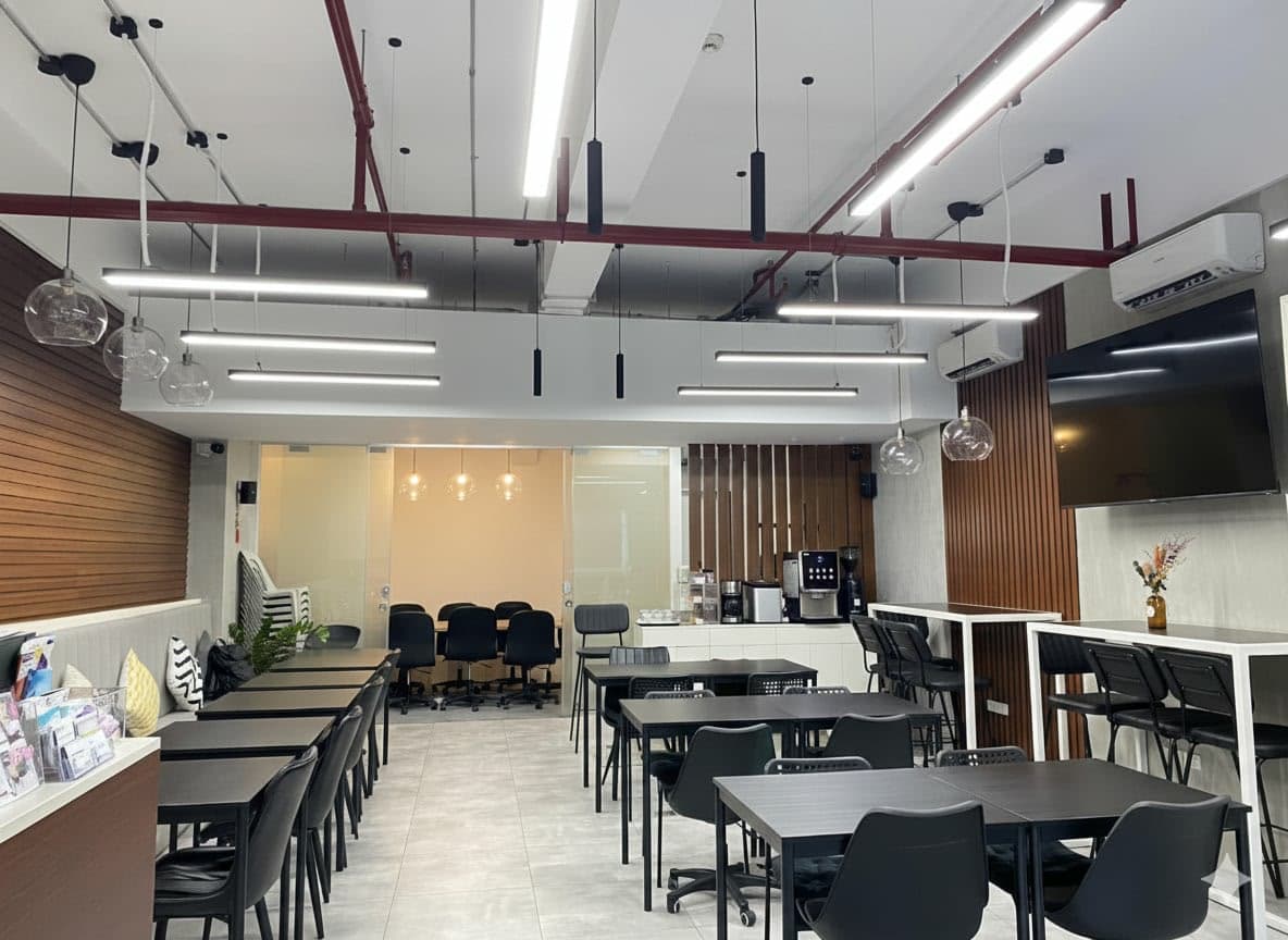 Modern coworking space with comfortable seating, meeting areas, and a fully equipped coffee station Modern coworking space with comfortable seating, meeting areas, and a fully equipped coffee station