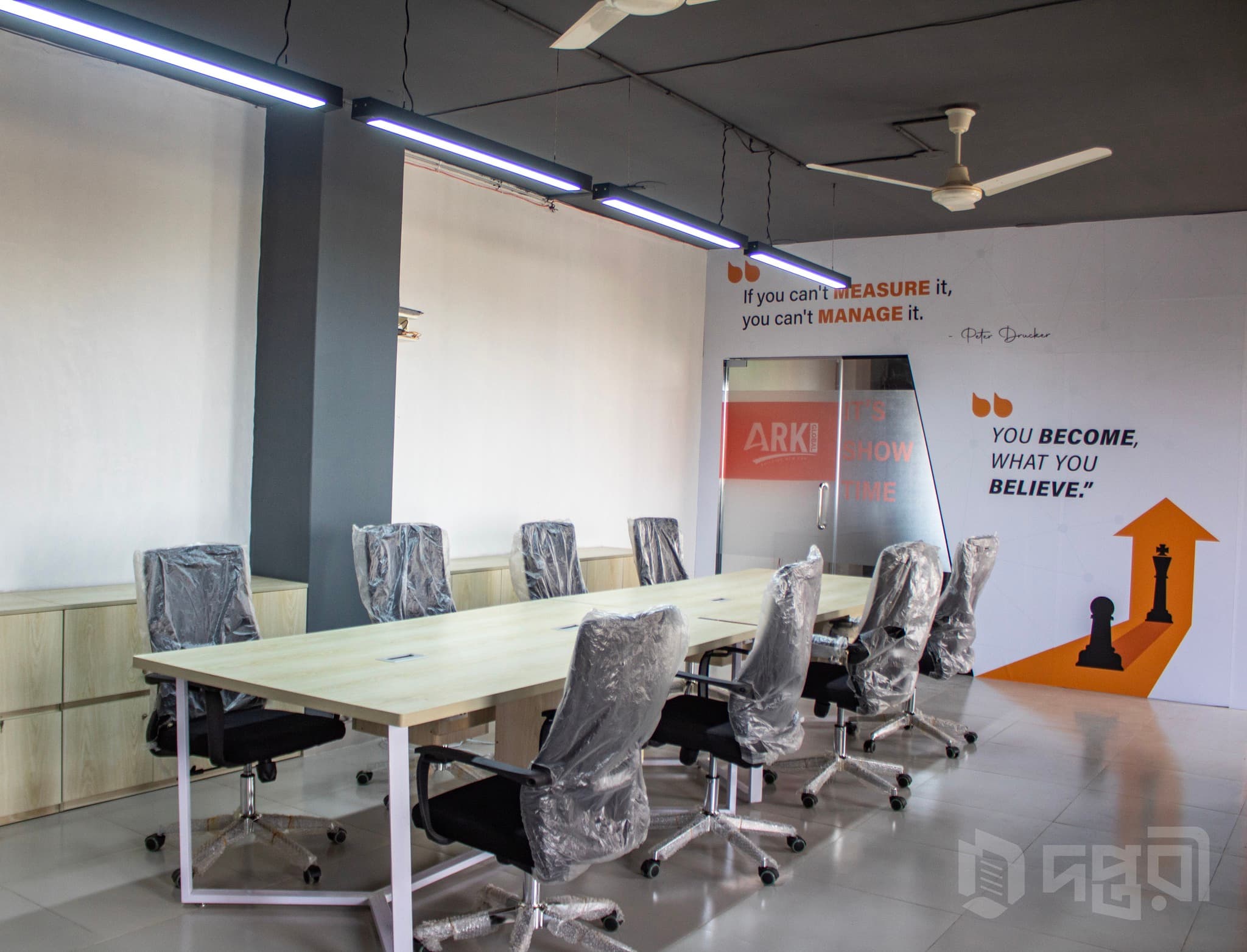 A modern meeting room at ARK Space featuring a spacious conference table, ergonomic chairs, clean interior design, and a prof A modern meeting room at ARK Space featuring a spacious conference table, ergonomic chairs, clean interior design, and a prof