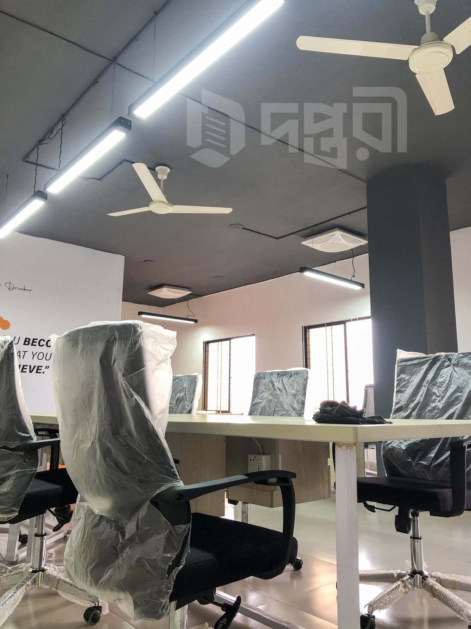 A shared coworking desk area offering ergonomic chairs, ample workspace, and a clean professional layout, ideal for freelance A shared coworking desk area offering ergonomic chairs, ample workspace, and a clean professional layout, ideal for freelance