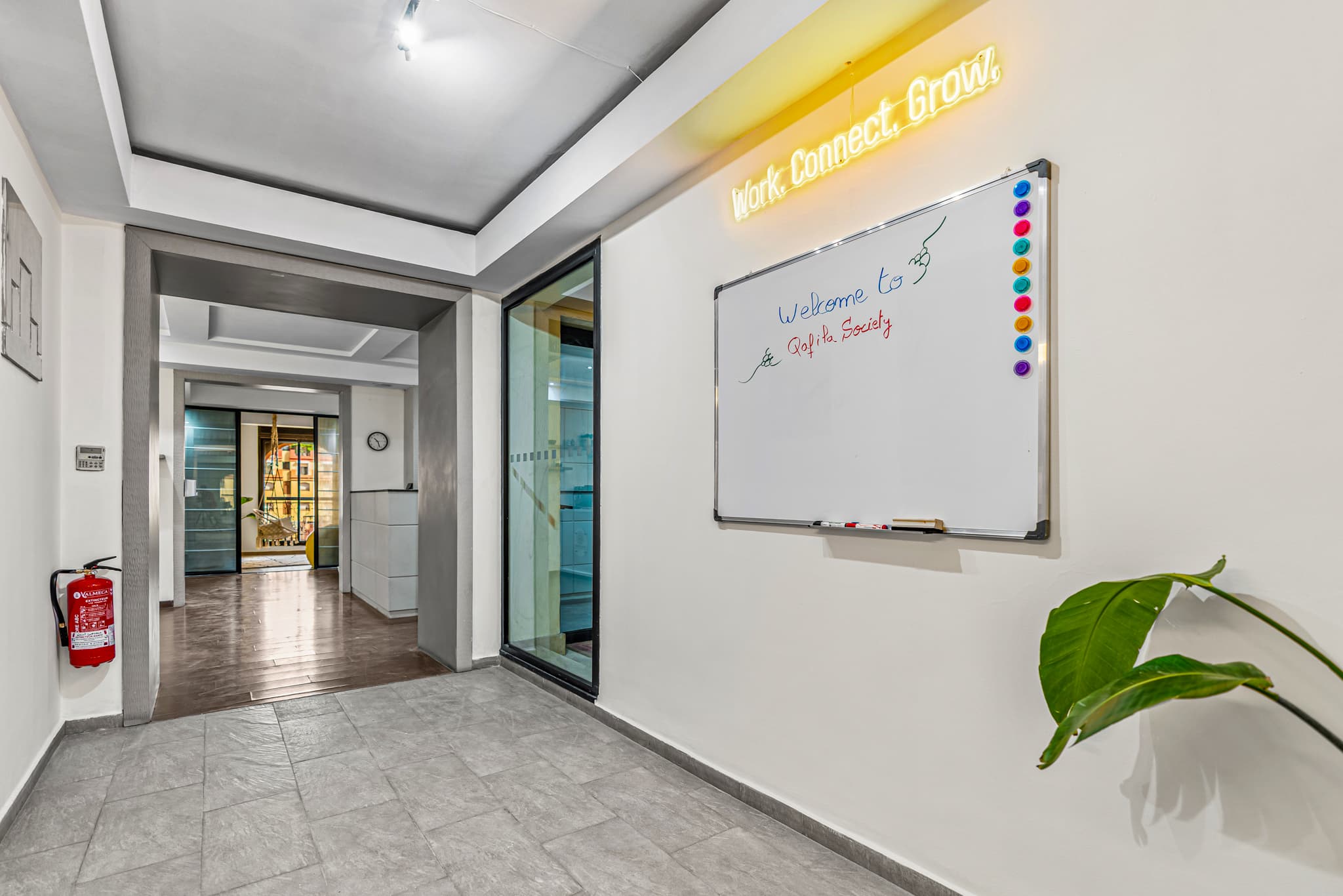 Welcome area at Qafila Society coworking space in Gueliz, Marrakech, featuring a glass-partitioned office, Welcome area at Qafila Society coworking space in Gueliz, Marrakech, featuring a glass-partitioned office,