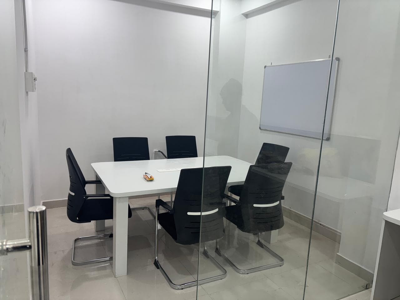 Private glass meeting room with elegant seating, ideal for meetings, discussions, and client interactions. Private glass meeting room with elegant seating, ideal for meetings, discussions, and client interactions.