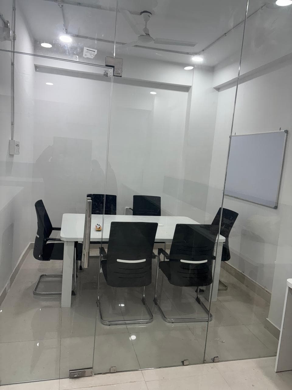Private meeting room with conference table and seating. Private meeting room with conference table and seating.