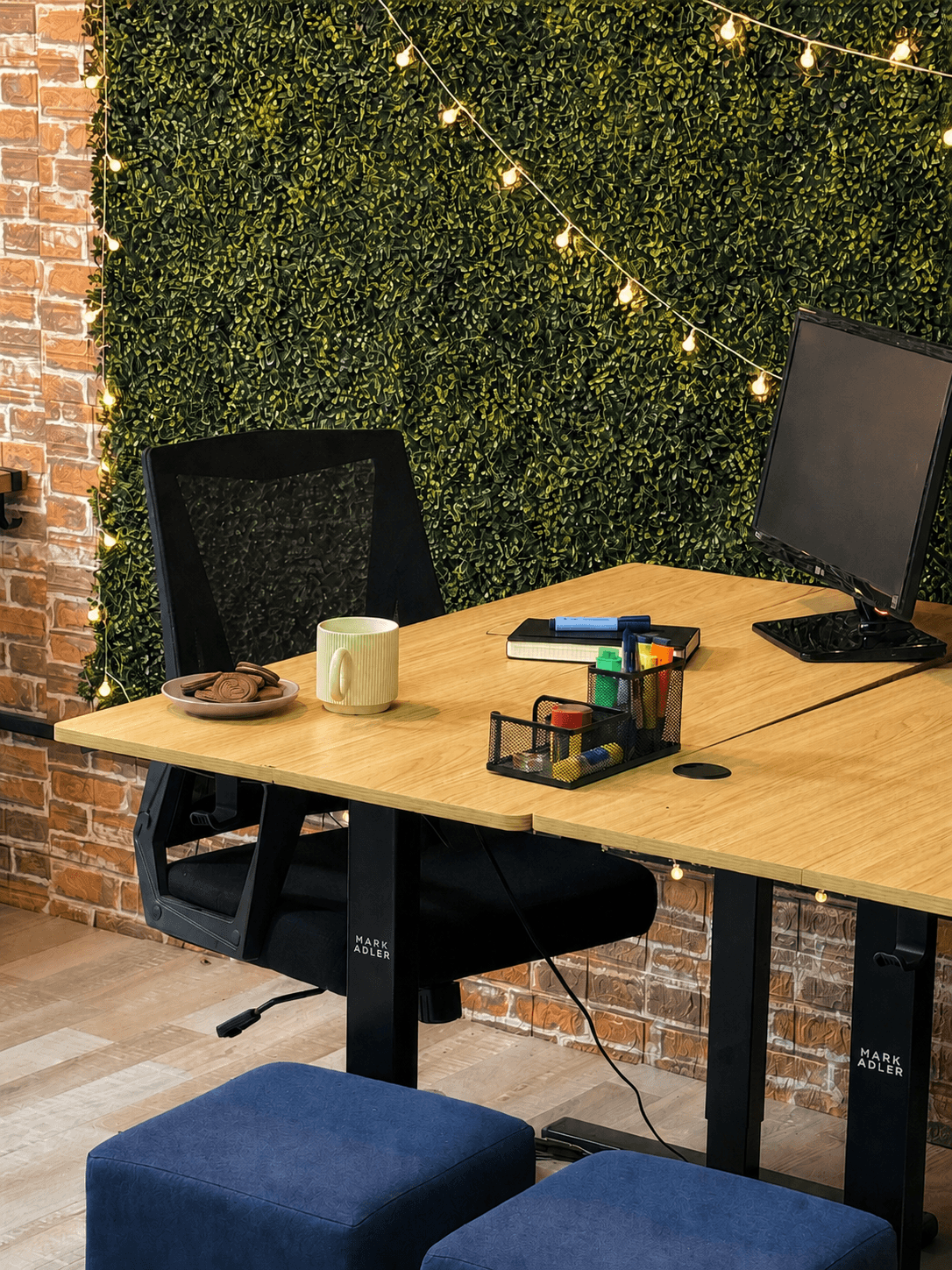 A standing desk with office supplies and a monitor setup for comfortable, focused work. A standing desk with office supplies and a monitor setup for comfortable, focused work.