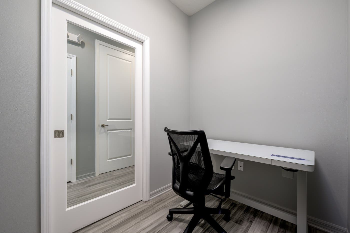 Lockable one-person private office with desk and task chair (representative layout). Lockable one-person private office with desk and task chair (representative layout).