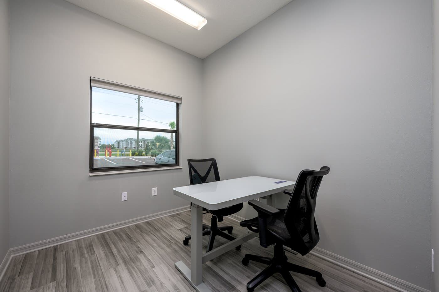 Private office with an exterior window, desk and two chairs (representative layout). Private office with an exterior window, desk and two chairs (representative layout).
