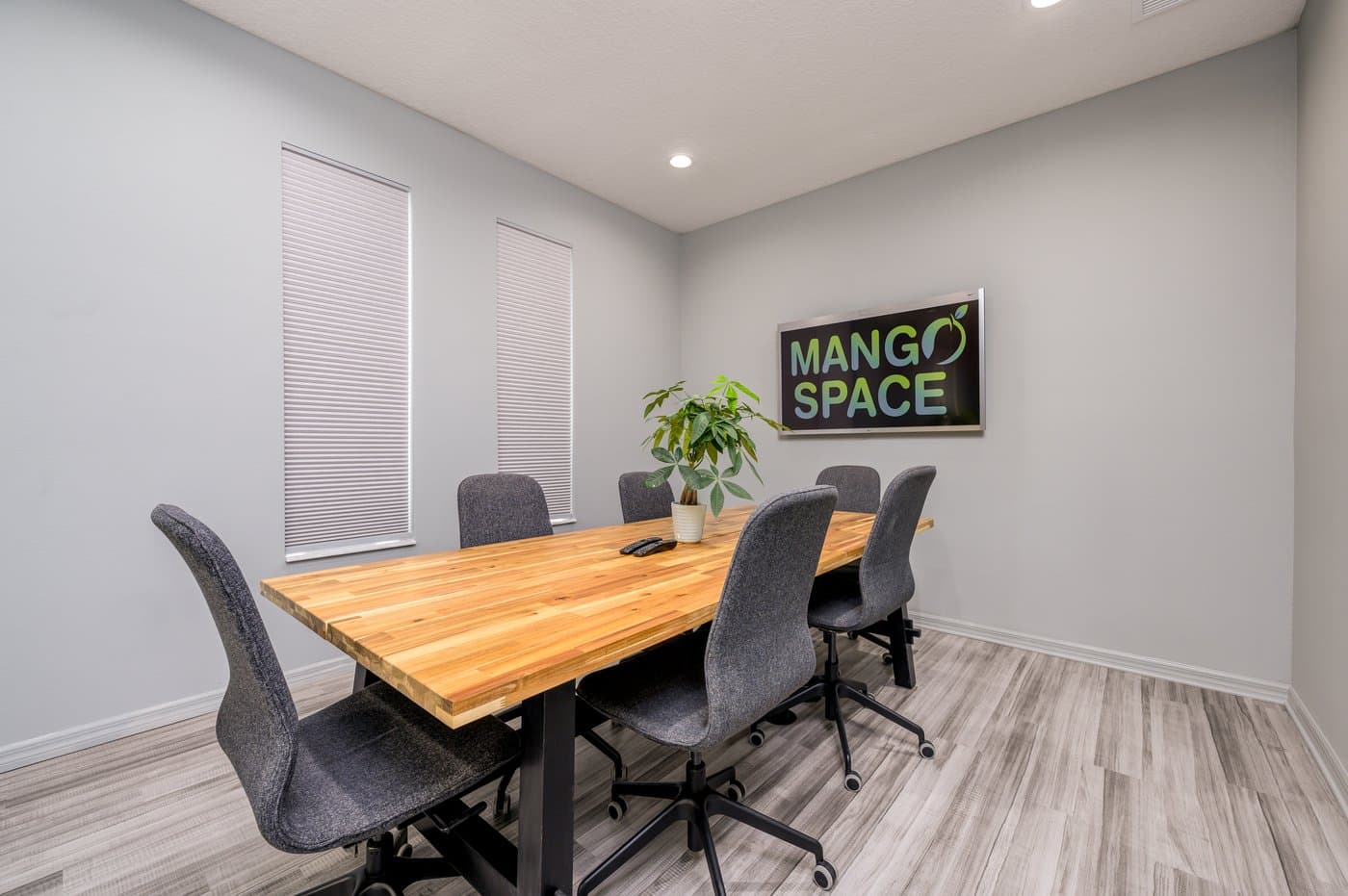 Six-seat meeting room with a butcher-block table, ideal for client meetings. Six-seat meeting room with a butcher-block table, ideal for client meetings.