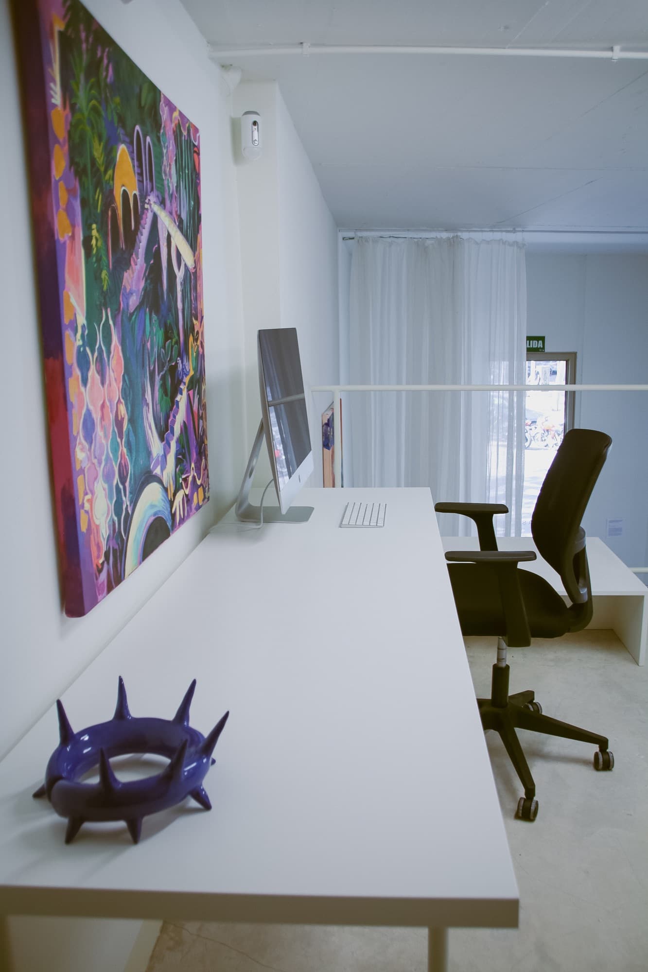 Long desk under the art on show Long desk under the art on show