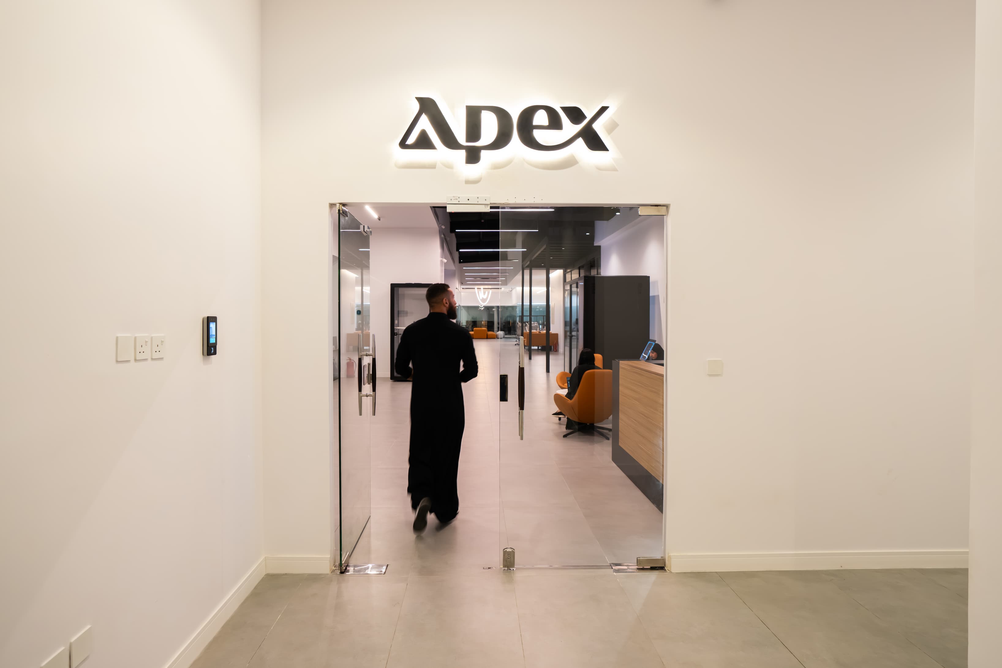 Entrance or Reception Area: An image featuring a sleek entrance marked with the “Apex” logo, highlighting a professional and Entrance or Reception Area: An image featuring a sleek entrance marked with the “Apex” logo, highlighting a professional and